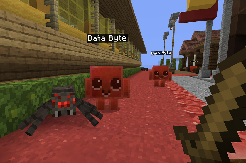 Minecraft Education game scene showing two blocky, red Data Byte creatures alongside a spider